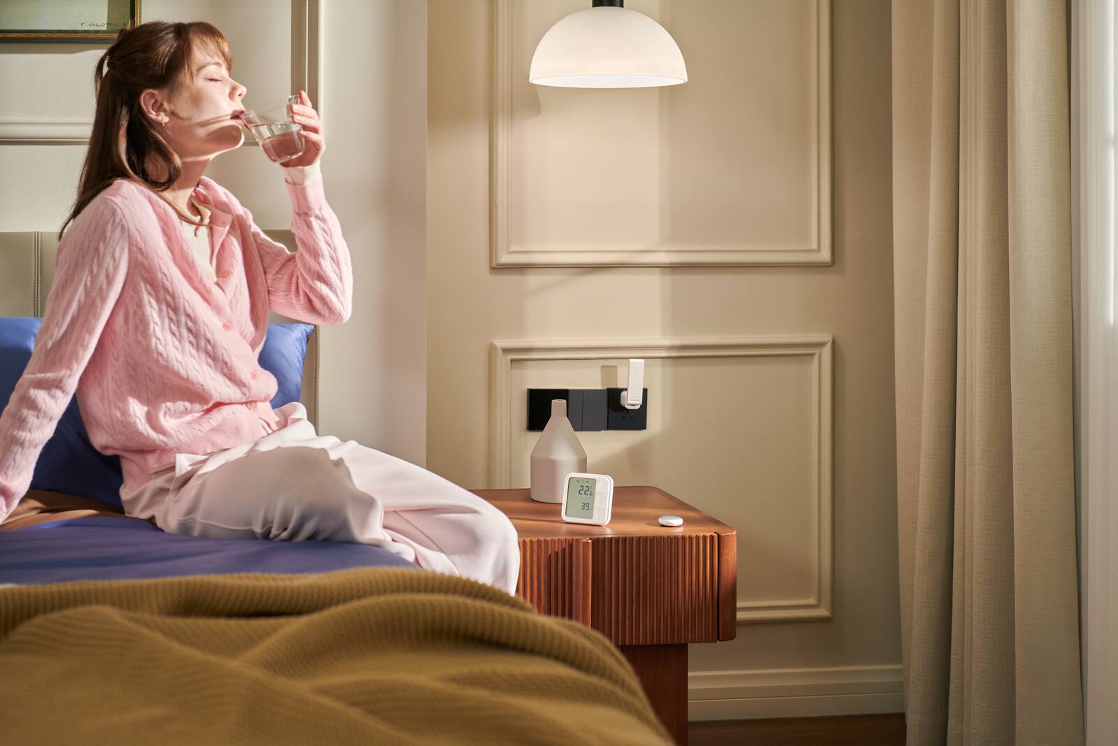 Resident using a warm bedroom with Aqara smart home devices