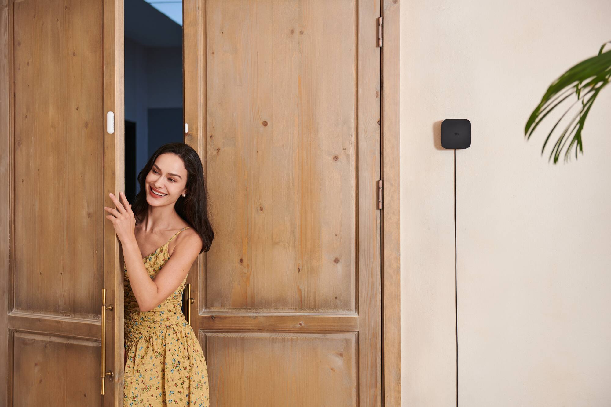 Resident arriving home with an Aqara hub installed beside the entrance