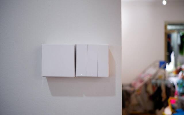 A row of white Aqara smart wall switches installed on a Singapore home wall