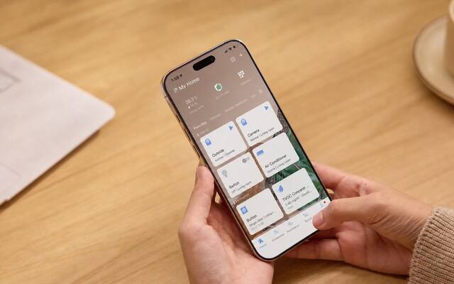 Person viewing the Aqara Home app dashboard on a phone