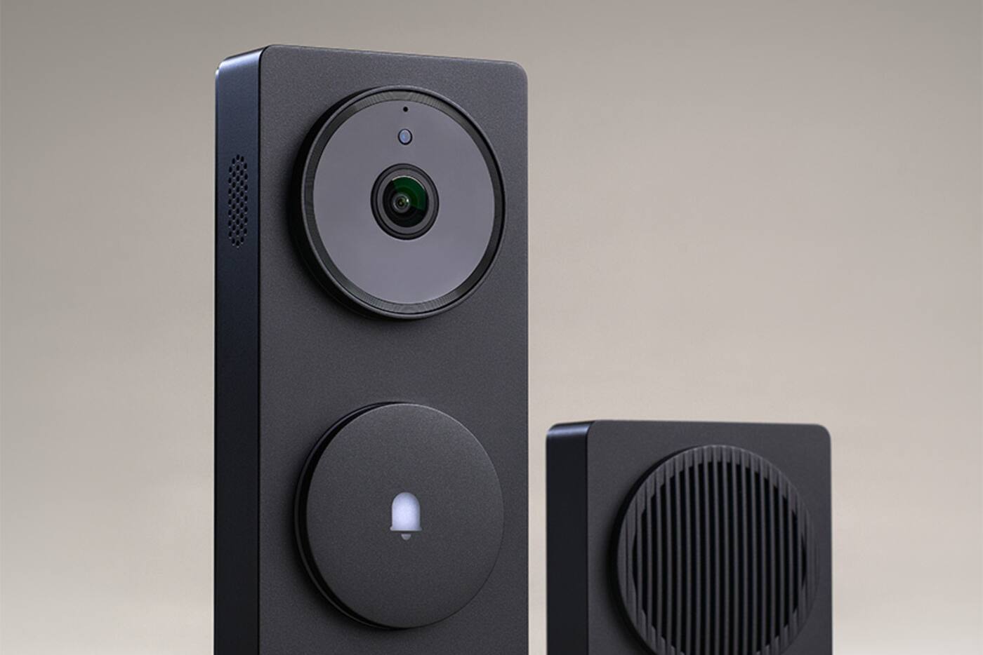 Aqara G410 video doorbell standing beside its round indoor chime hub