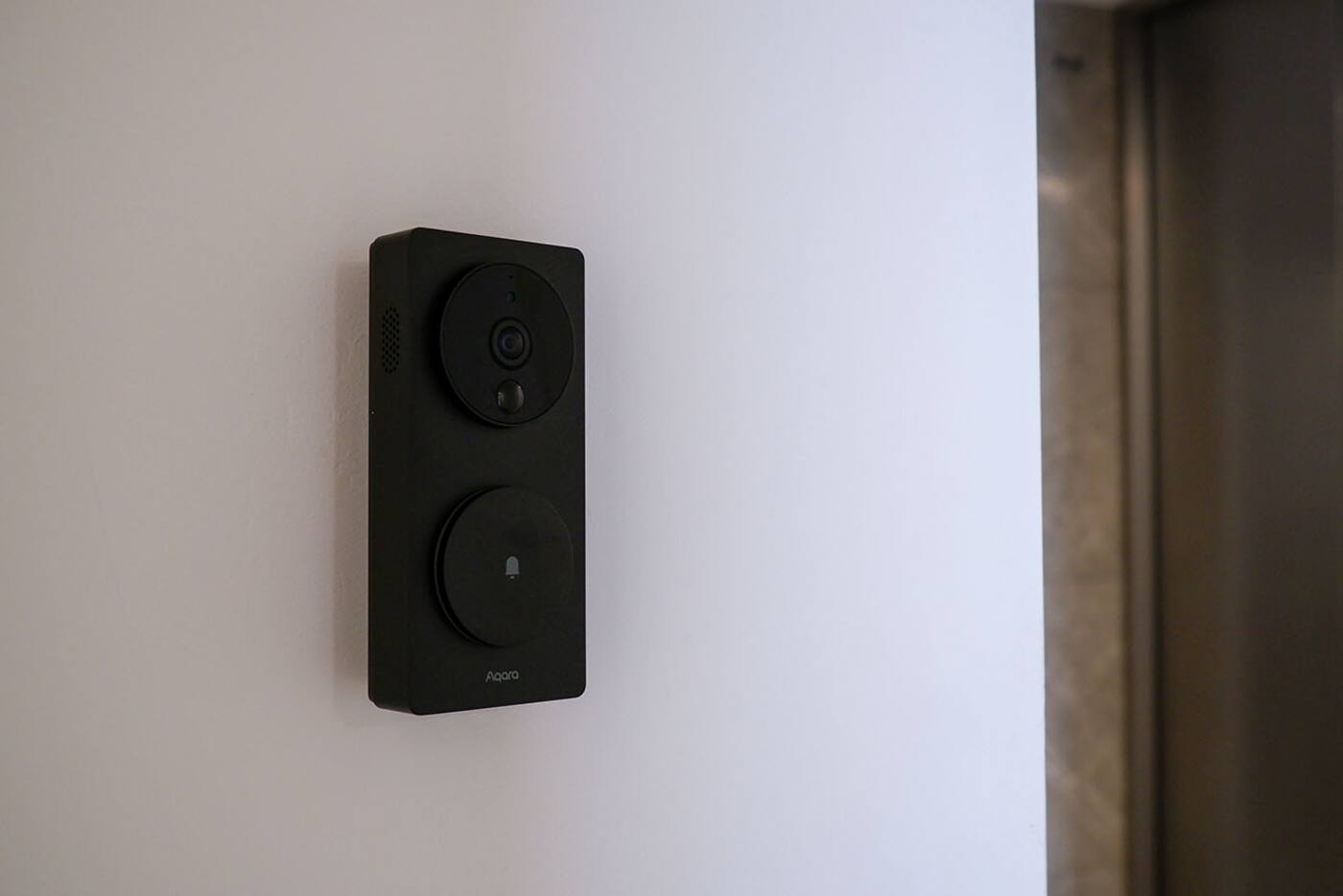 Aqara video doorbell installed beside a home entrance