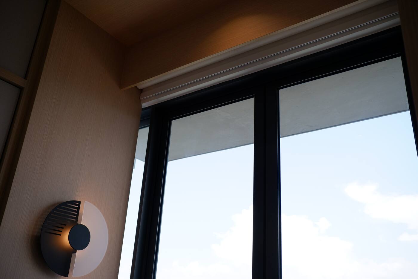 Finished motorised roller blind headrail above a window