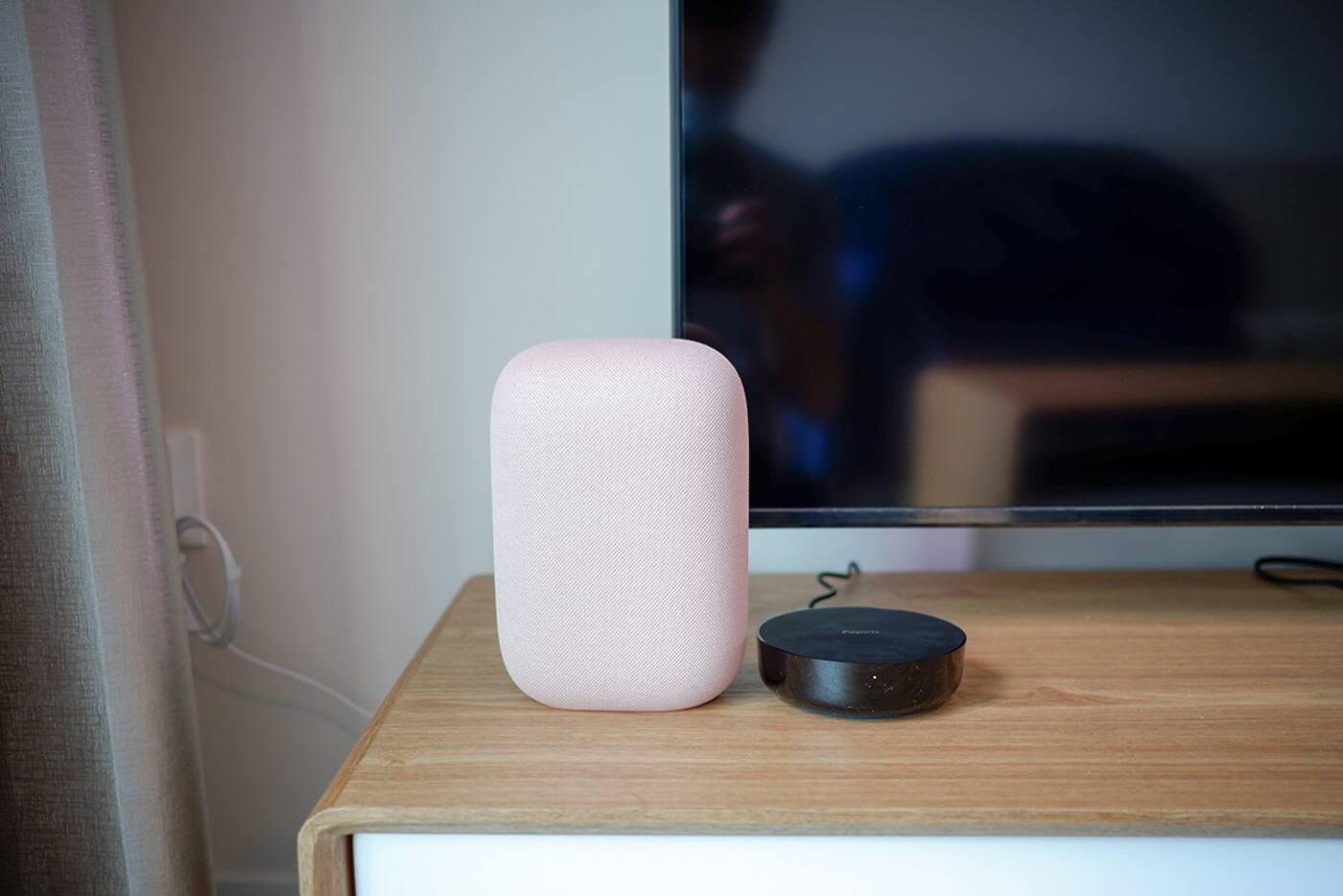 Google smart speaker positioned beside an Aqara hub