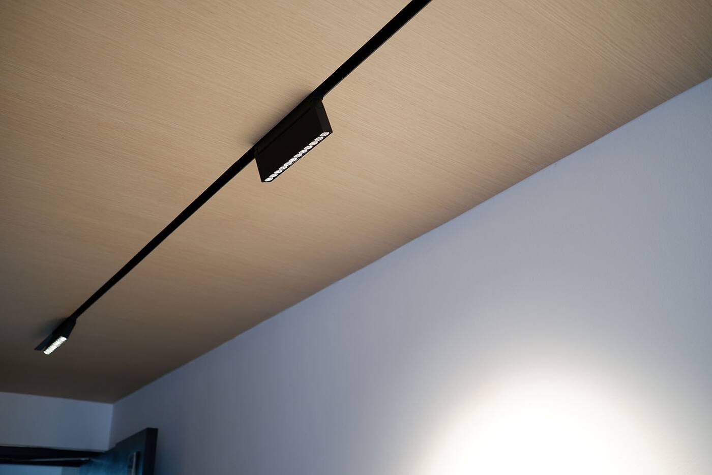 Adjustable track lights installed on a timber ceiling in a Singapore home