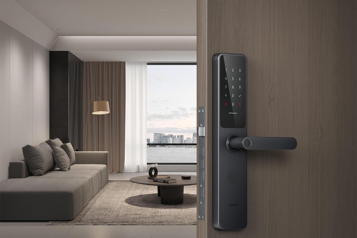 Black Aqara A100 mortise smart lock installed on a timber apartment door
