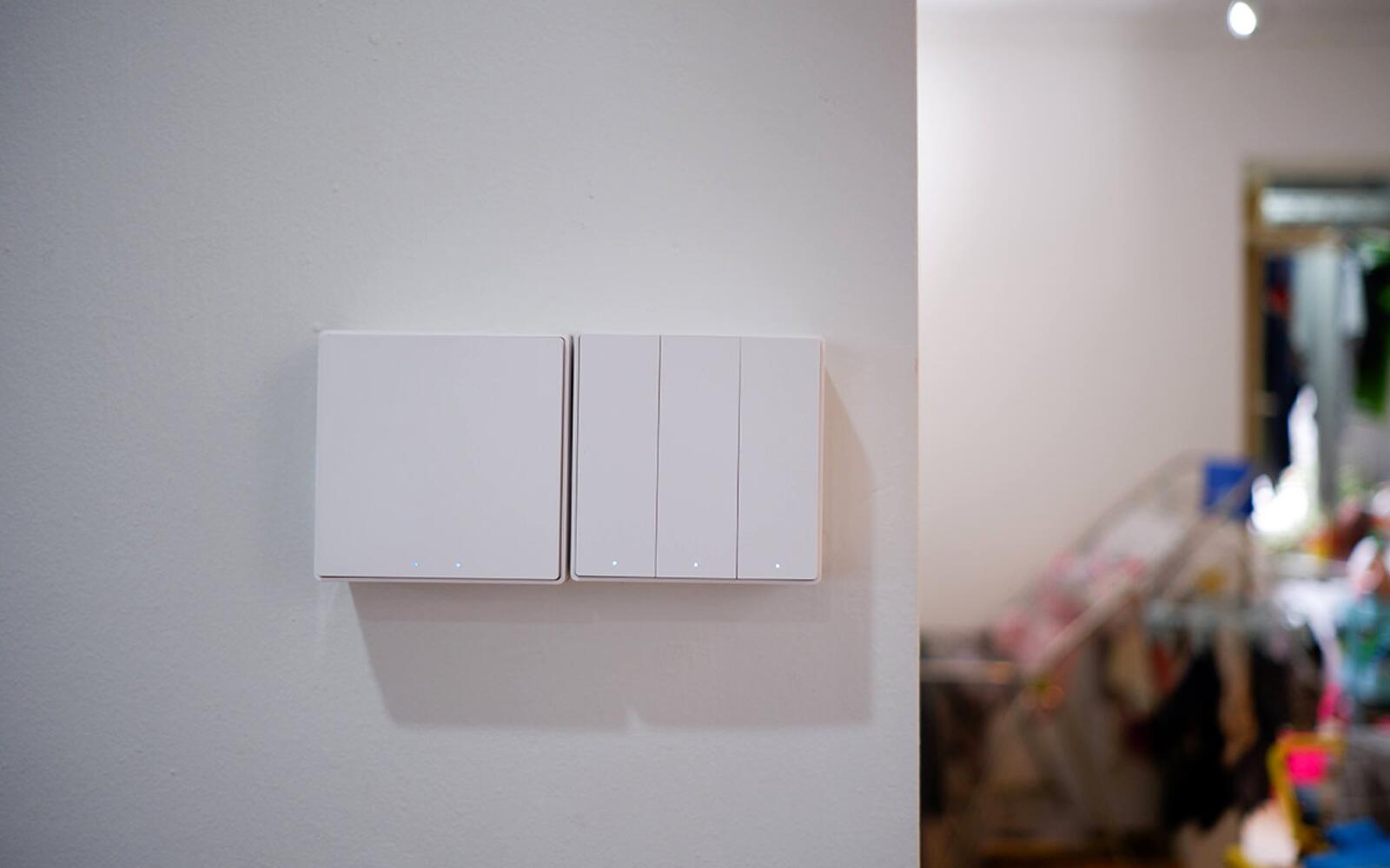 A row of white Aqara smart wall switches installed on a Singapore home wall