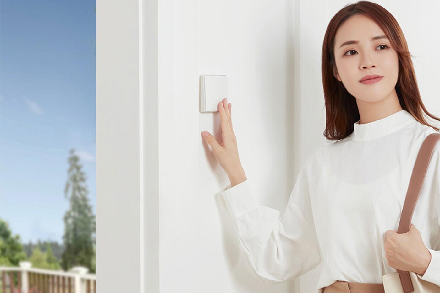Aqara smart wall switch controlling a ceiling light in a furnished room