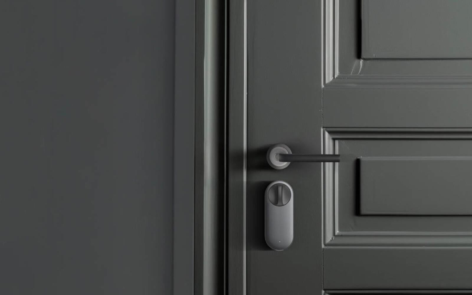 Aqara U200 retrofit smart lock mounted on the inside of a grey entrance door