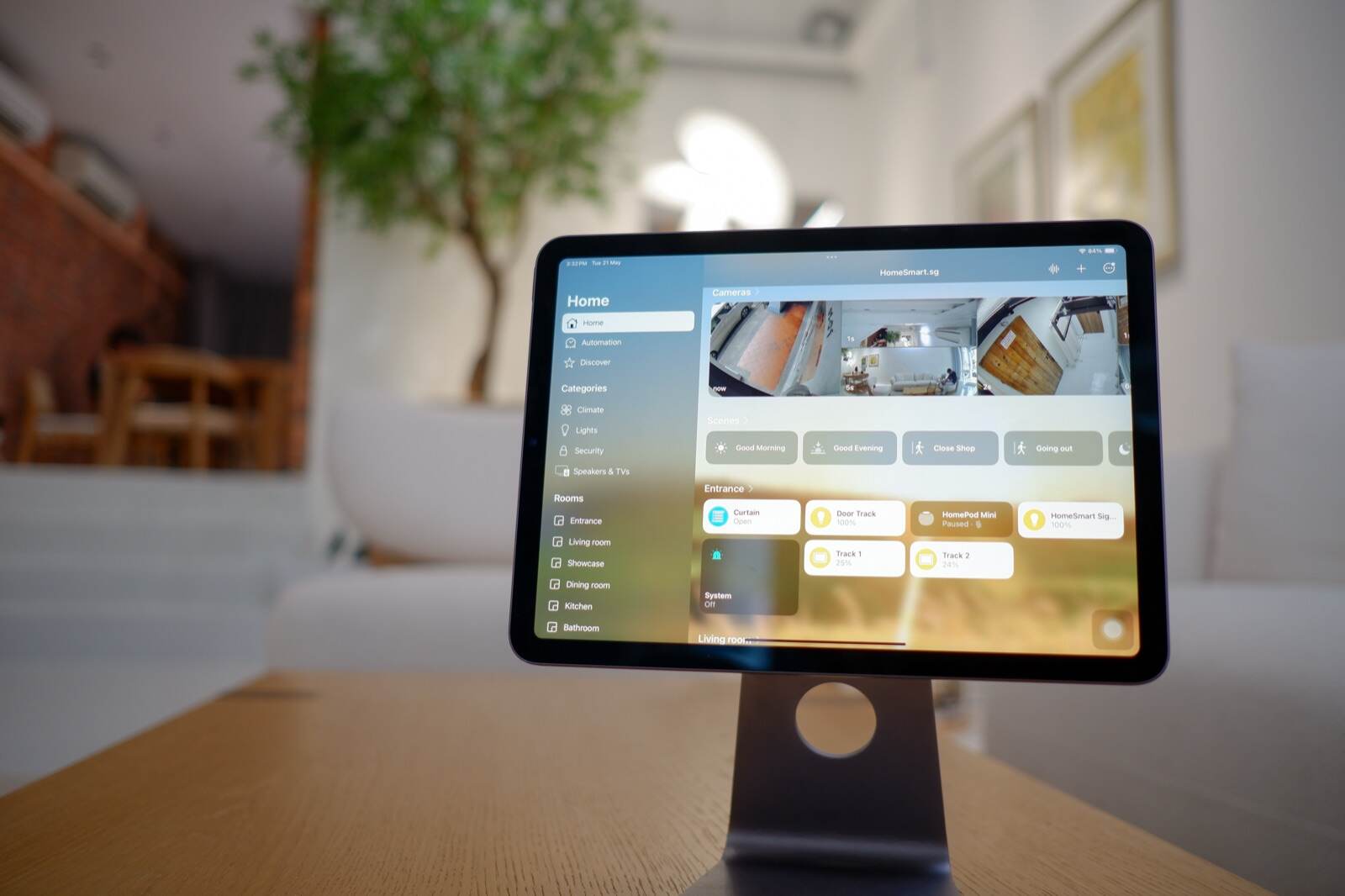 Apple Home scenes on a tablet at the Experience Centre, the lounge behind it