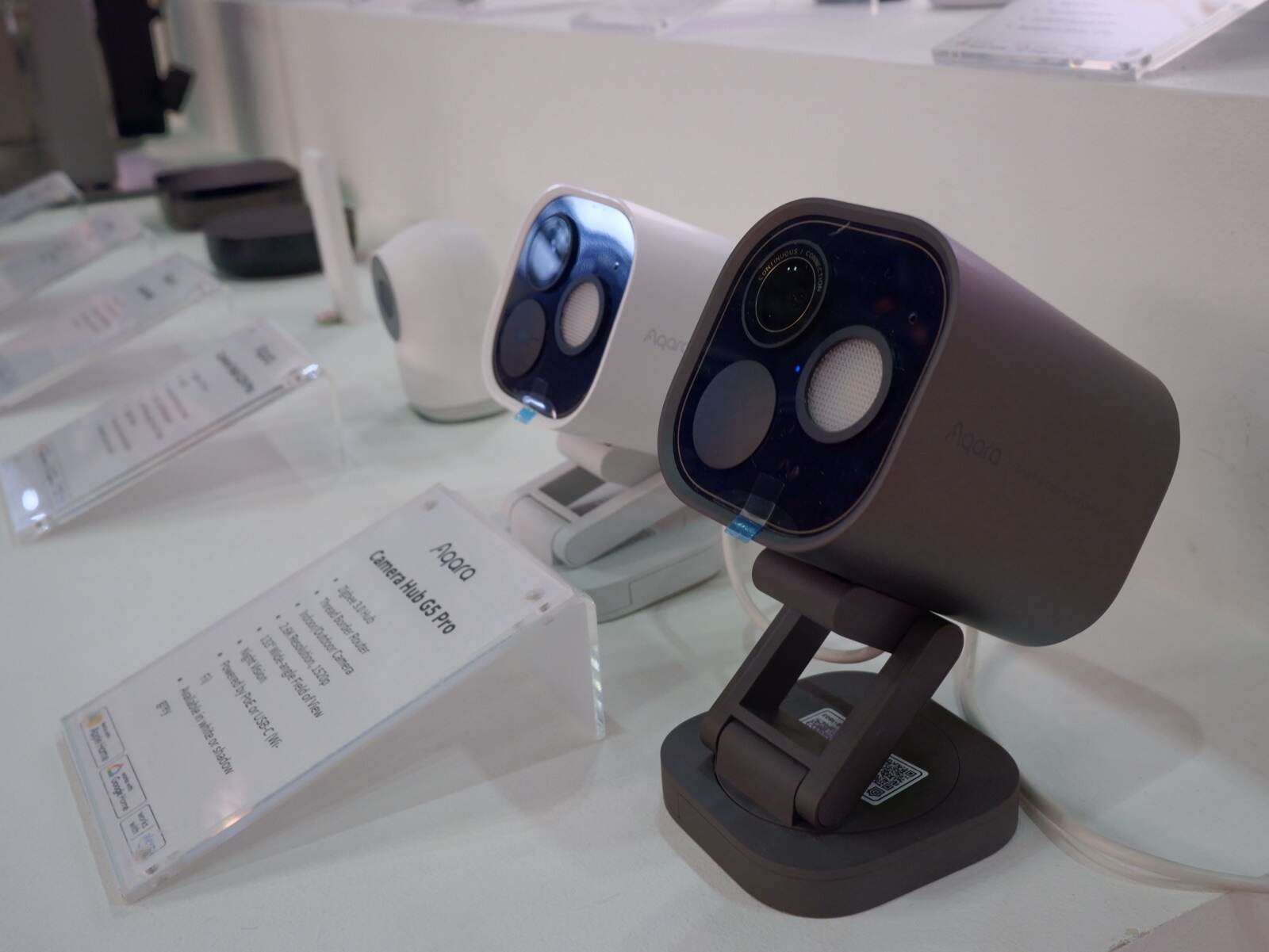 Aqara security cameras on display at the Experience Centre, spec cards alongside