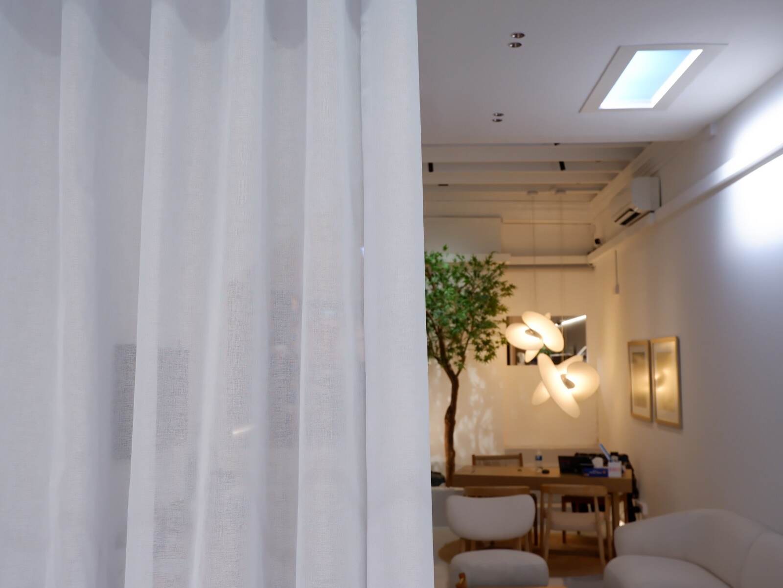 Sheer motorised S-fold curtains drawn across the lounge of the Experience Centre