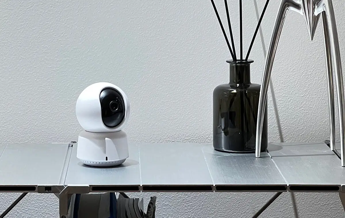 Camera E1 on a shelf in a calm, uncluttered corner of a home
