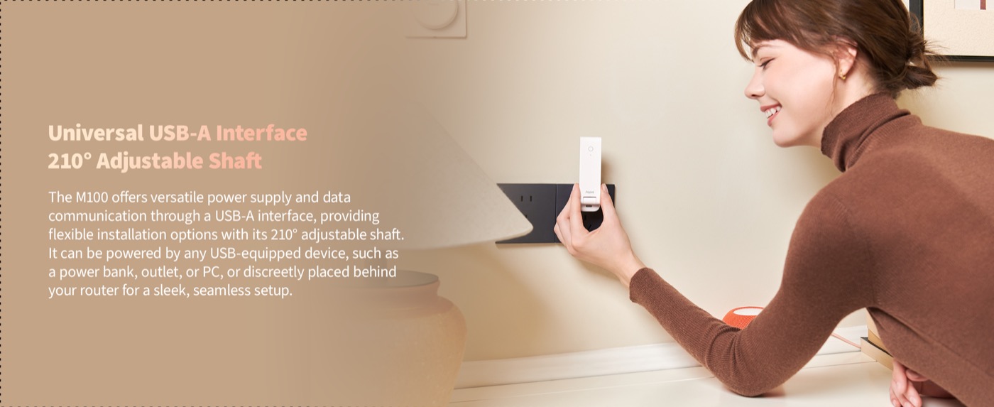A hand adjusting the Hub M100's pivoting shaft in a wall socket