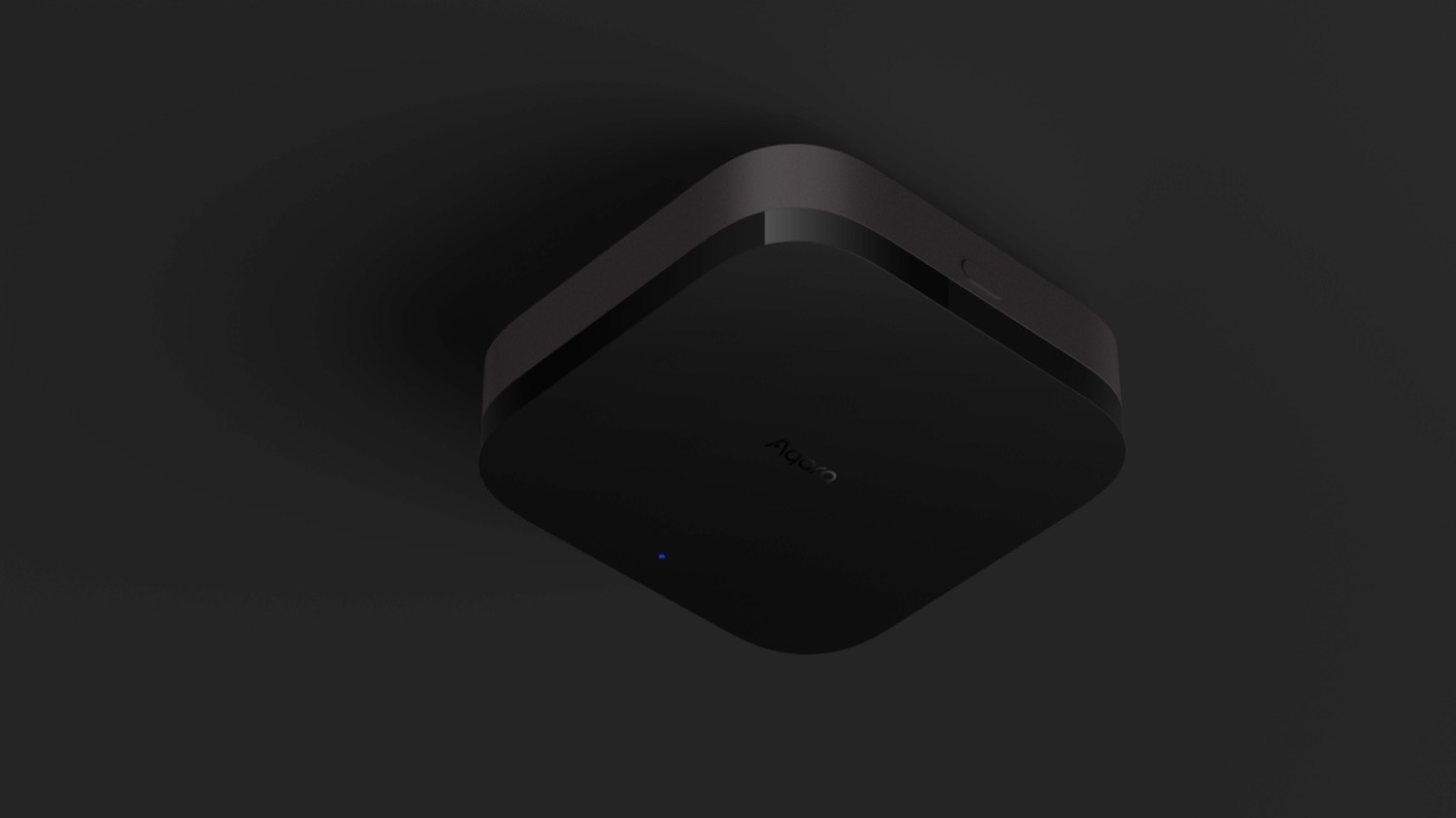 Top-down view of the Aqara Hub M3 on a dark surface