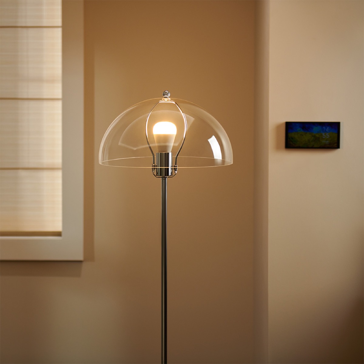 Aqara LED Bulb T2 glowing warm white inside a floor lamp in a softly lit living room