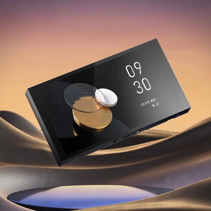 Aqara MagicPad S1 Plus panel floating over sunset sand dunes, showing its full-screen clock face
