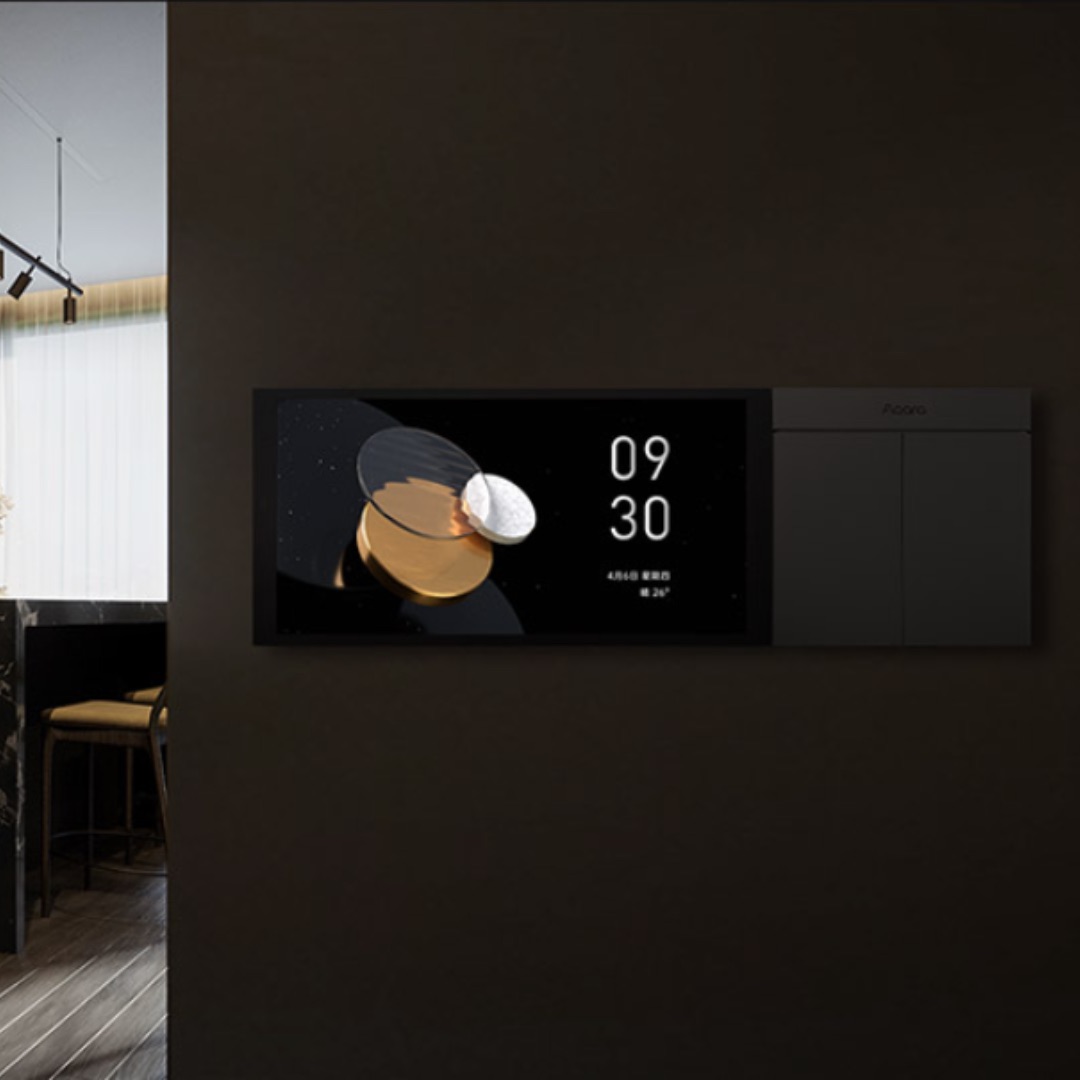 MagicPad S1 Plus mounted on a dark wall next to a matching gang switch, overlooking a dining area