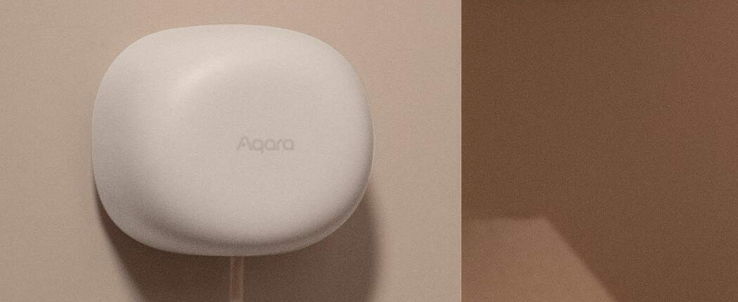 Aqara Presence Sensor FP1E mounted on a warmly lit bedroom wall