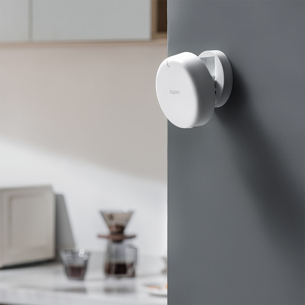 Presence Sensor FP2 mounted on a grey wall beside a bright kitchen counter