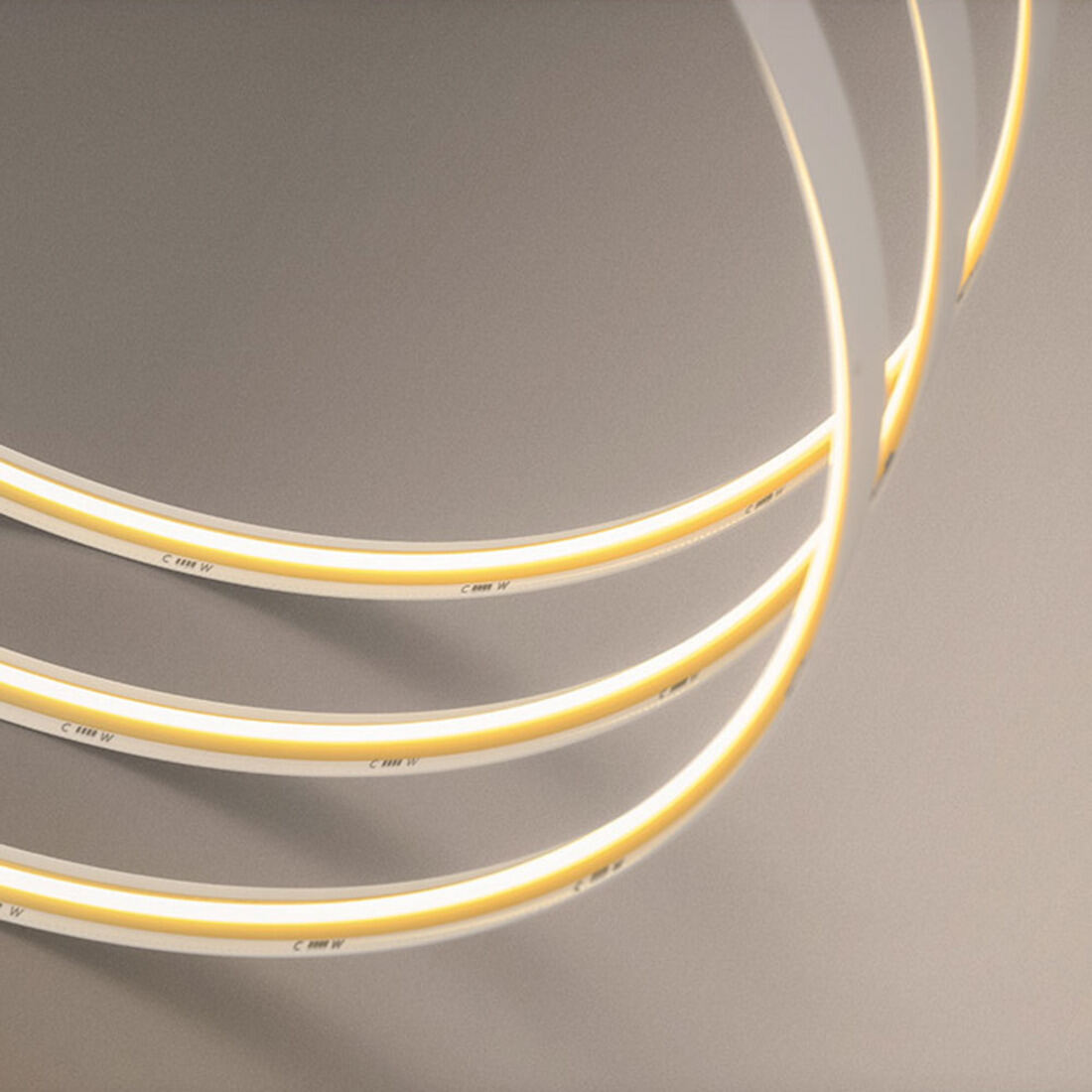 Close-up of the high-density COB LED strip glowing in a smooth, dotless warm-white line