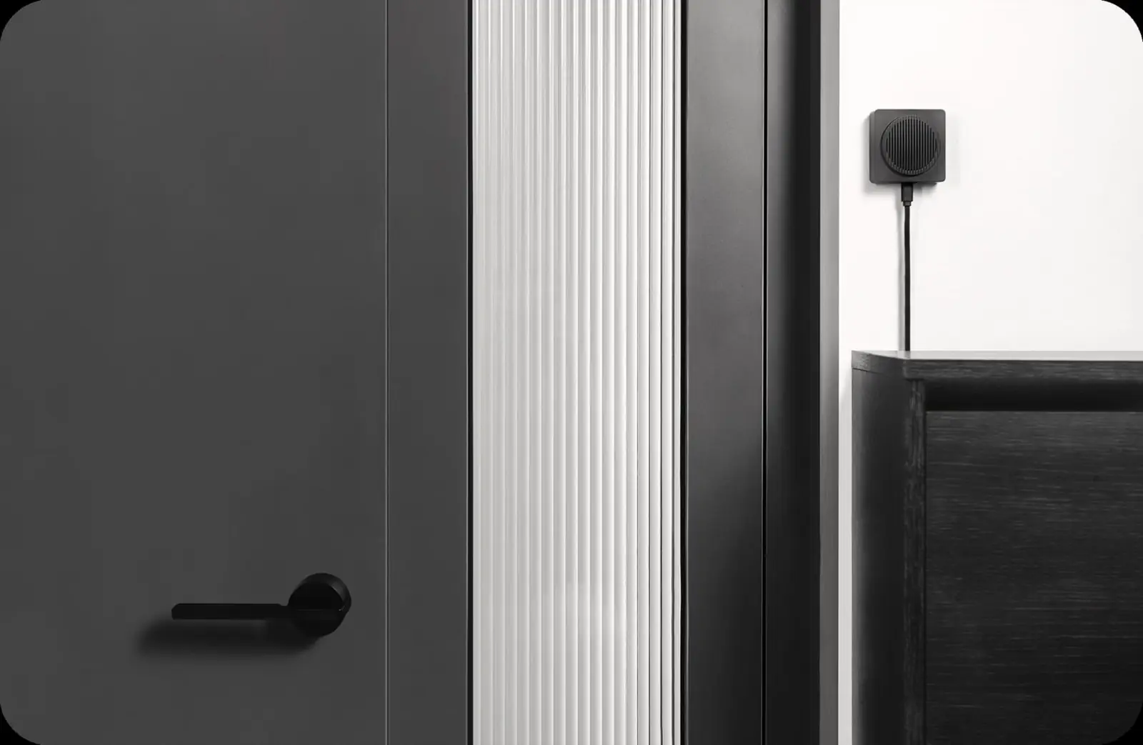 The G4 doorbell at a modern doorway with its indoor chime resting discreetly on a console