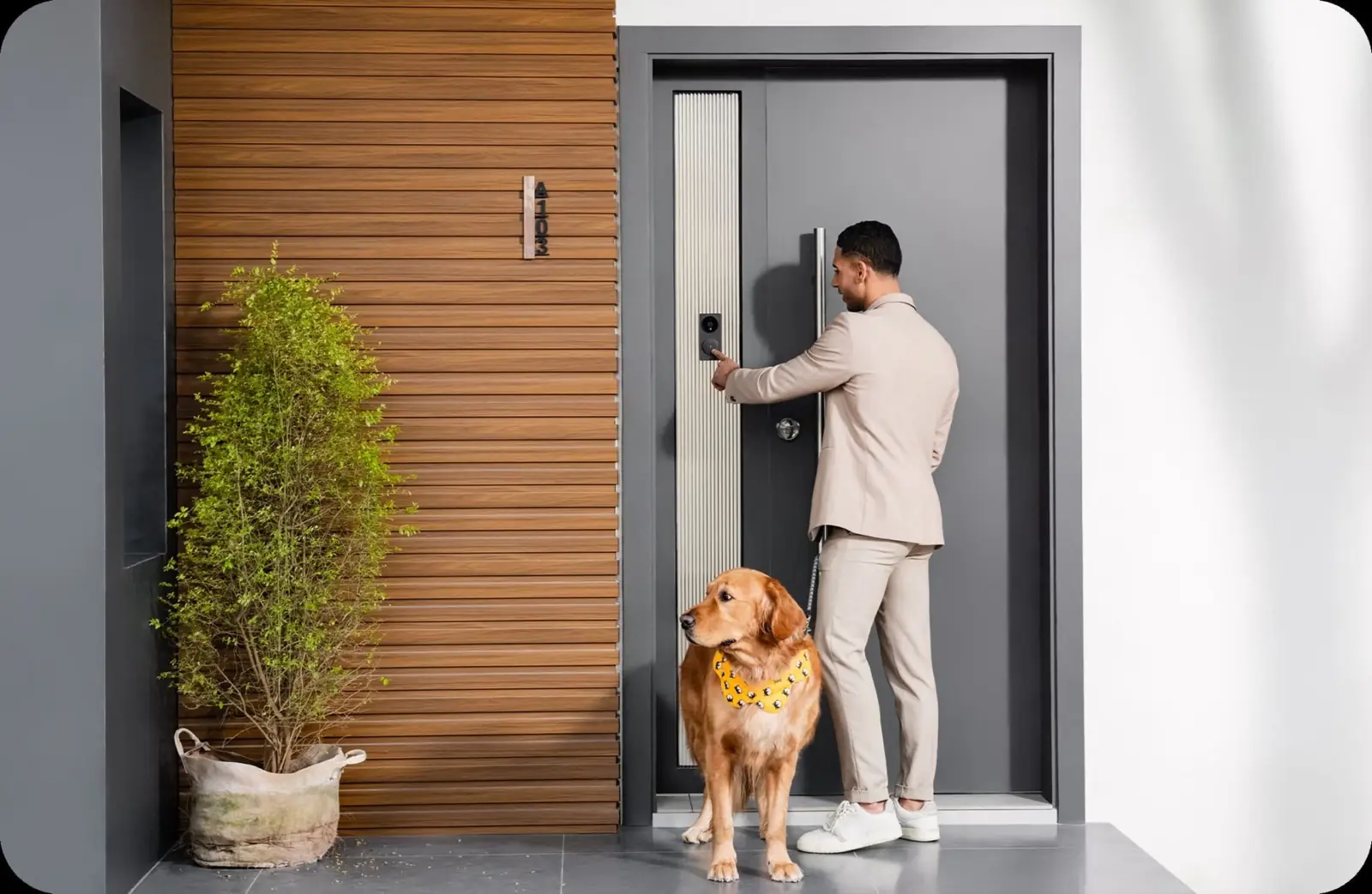A man and his dog at a modern front door with the Aqara G4 doorbell mounted beside it