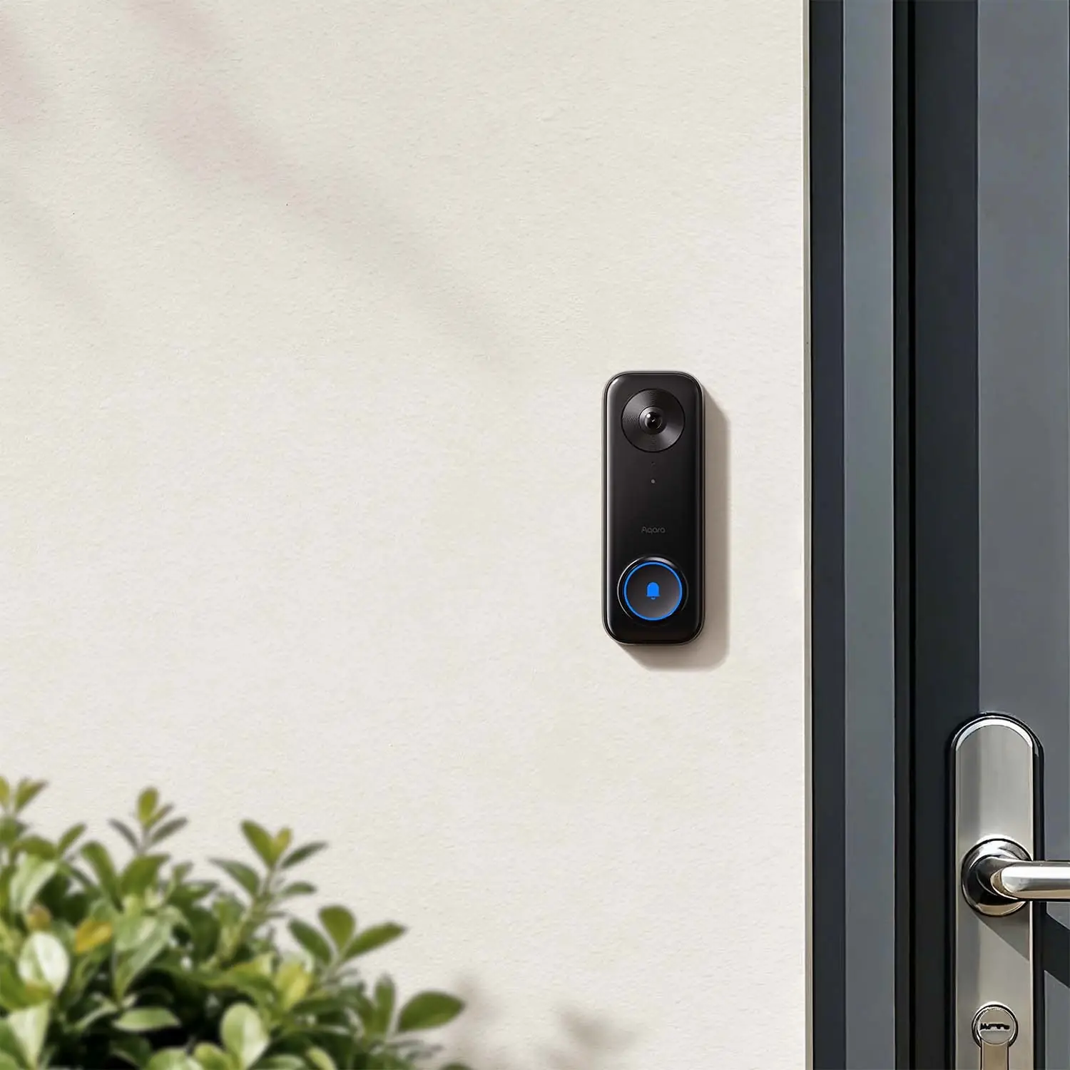 Aqara Smart Video Doorbell G400 mounted beside a modern glass front door