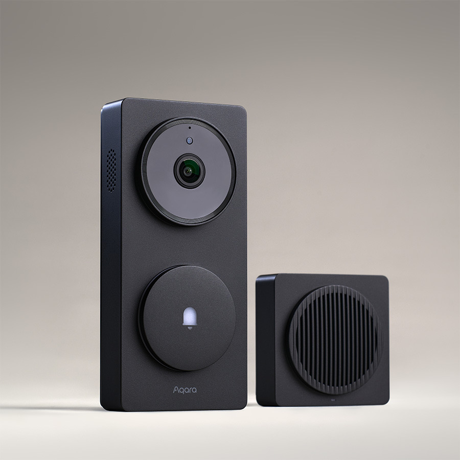 Aqara G410 doorbell and chime repeater in black on a warm studio backdrop