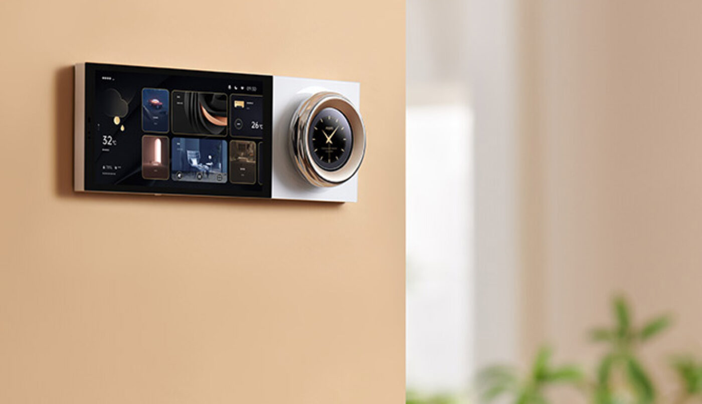 Aqara Touchscreen Dial V1 mounted beside a control panel on a warm-toned living room wall